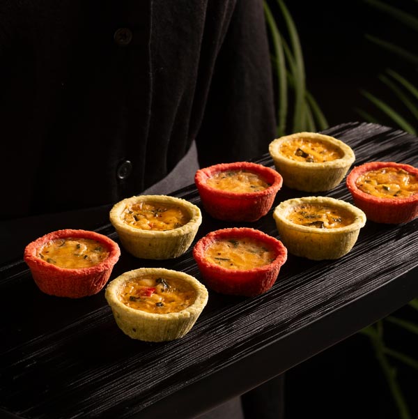 Vibrant-Quiches-on-Tray-With-Model